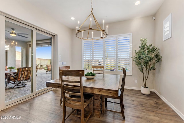 dining space with wood finished floors, ceiling fan with notable chandelier, baseboards, and recessed lighting