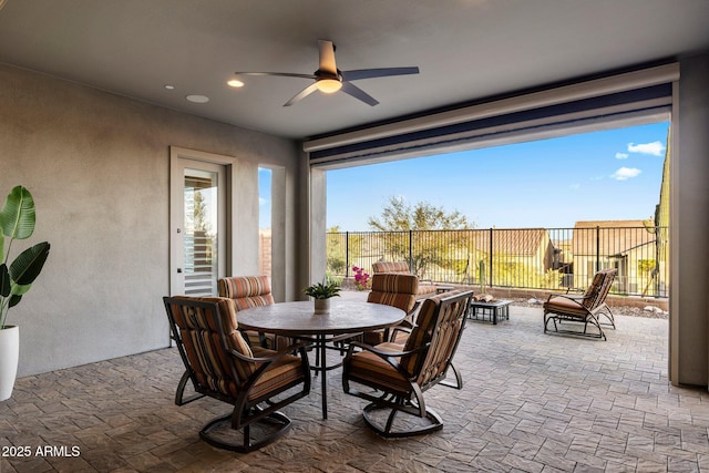 exterior space featuring stone tile floors, a ceiling fan, and recessed lighting