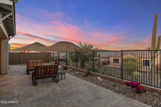 view of patio featuring a mountain view, an outdoor living space, and a fenced backyard