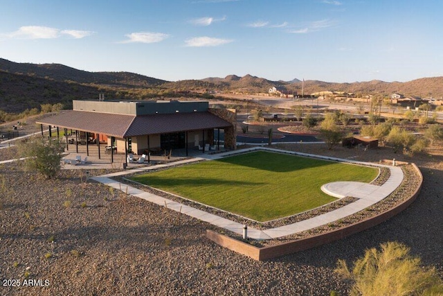back of house featuring a patio, a yard, and a mountain view