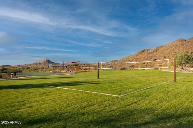 view of property's community featuring a yard, a mountain view, and volleyball court