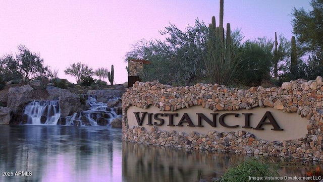 community sign with a water view