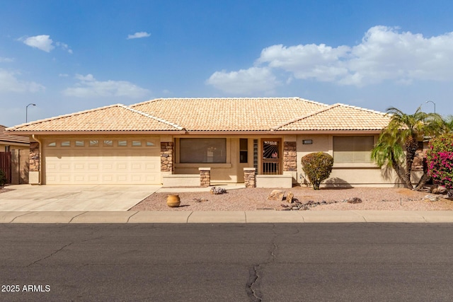 single story home with an attached garage, a tiled roof, concrete driveway, stone siding, and stucco siding