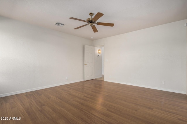 unfurnished room featuring ceiling fan, wood finished floors, visible vents, and baseboards