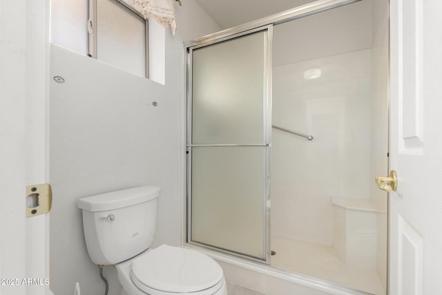 full bath with toilet and an enclosed shower