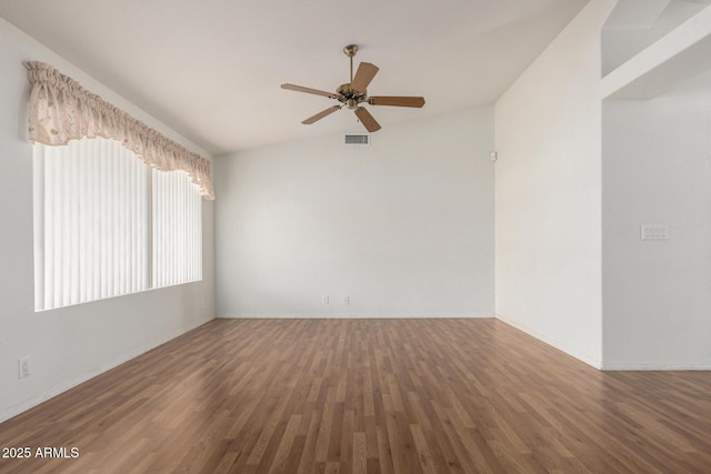 empty room featuring a ceiling fan, baseboards, visible vents, and wood finished floors