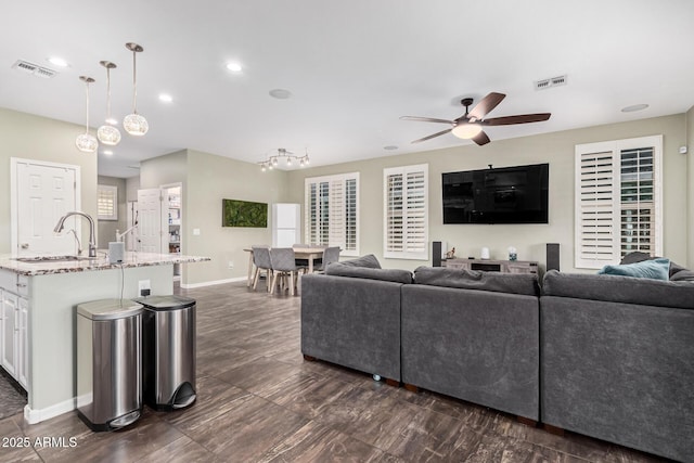 living room with sink and ceiling fan