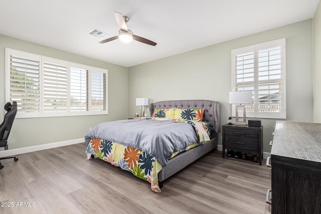 bedroom with ceiling fan and light wood-type flooring