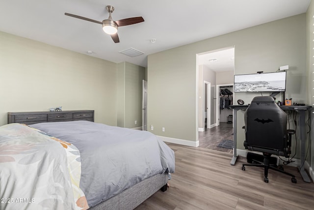 bedroom with ceiling fan and light hardwood / wood-style floors