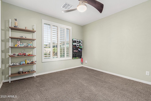 empty room with ceiling fan and carpet