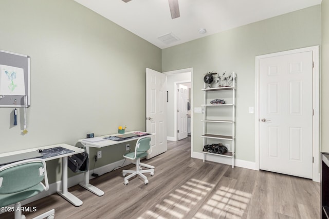 office space featuring ceiling fan and light hardwood / wood-style floors