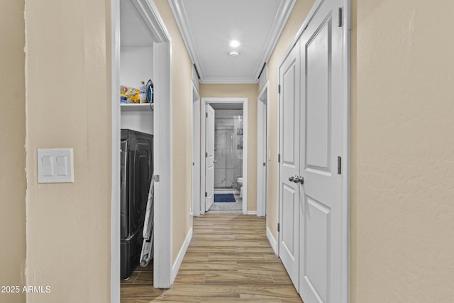 19239 W Elm St, Litchfield Park, AZ 85340 - hall with washer and dryer, crown molding, light wood-style flooring, and a textured wall