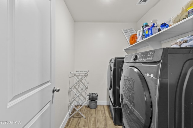 19239 W Elm St, Litchfield Park, AZ 85340 - laundry area with wood finished floors and independent washer and dryer