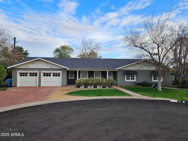 single story home featuring a garage and a front yard