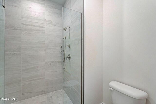 bathroom featuring toilet and walk in shower