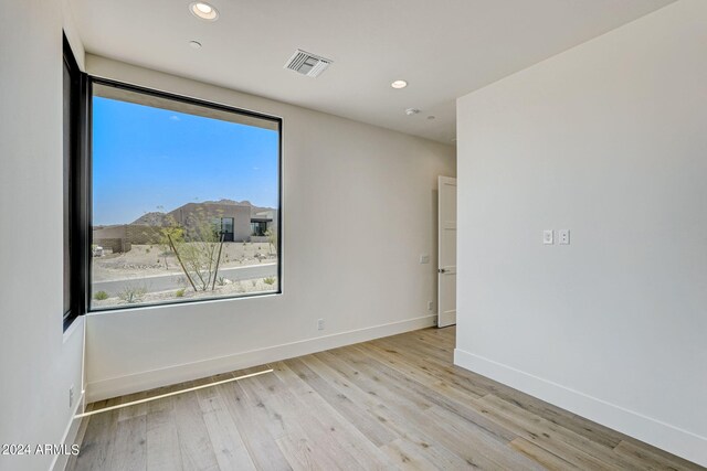 spare room featuring light wood-type flooring