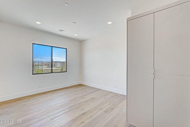 unfurnished room with light hardwood / wood-style floors