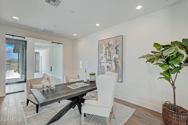 home office with light hardwood / wood-style floors