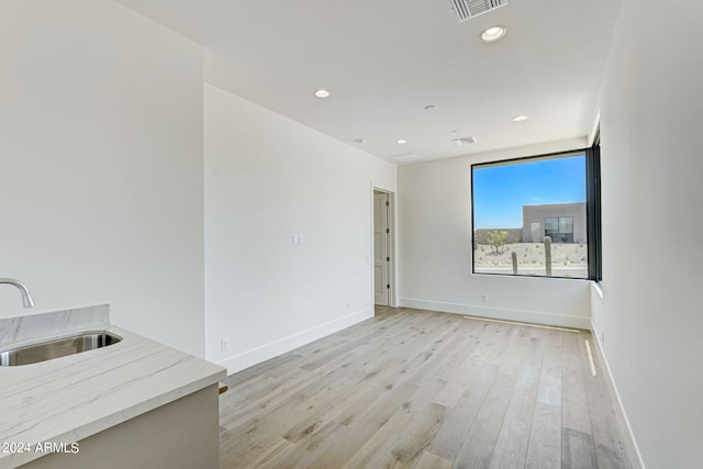 interior space with sink and light hardwood / wood-style flooring