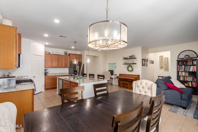 tiled dining room with sink and an inviting chandelier