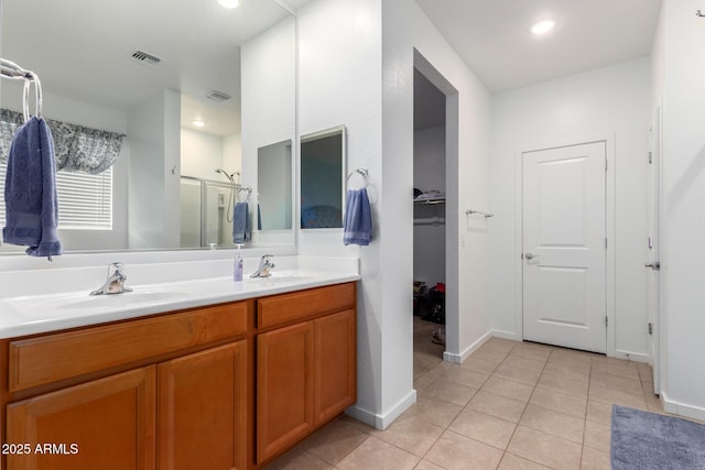 bathroom featuring vanity, an enclosed shower, and tile patterned flooring