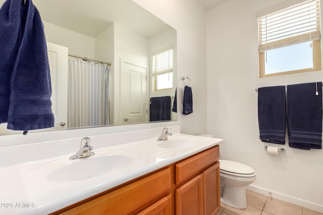 bathroom with vanity, tile patterned flooring, toilet, and plenty of natural light