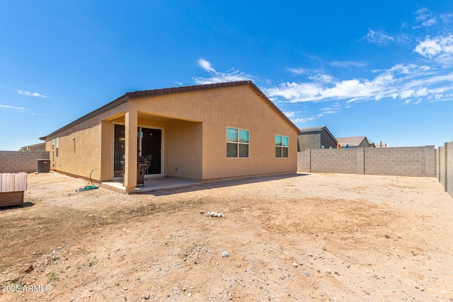 rear view of property featuring a patio and cooling unit