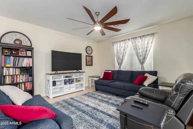 tiled living room featuring ceiling fan