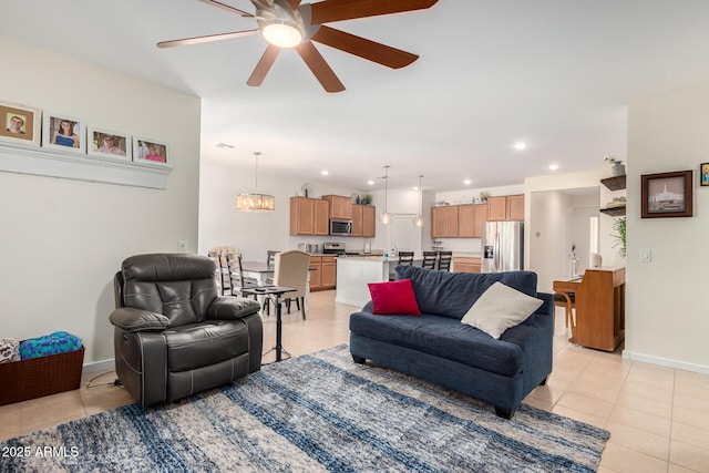 tiled living room featuring ceiling fan with notable chandelier