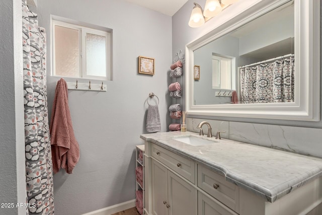 bathroom featuring vanity and baseboards