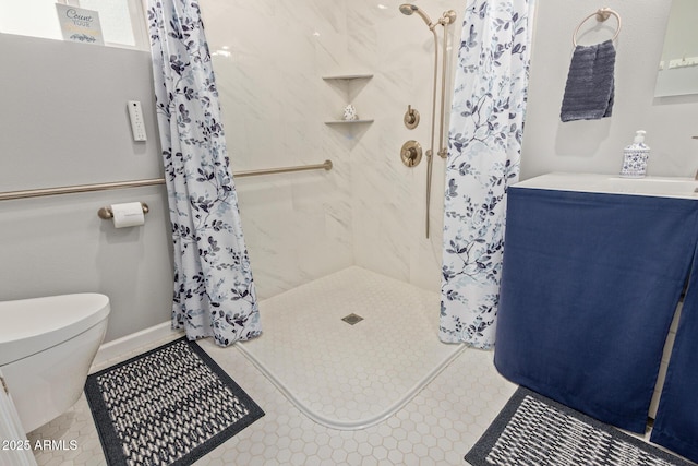 bathroom with toilet, a shower stall, and tile patterned flooring