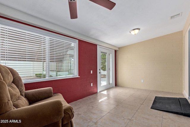 tiled foyer entrance with visible vents and a ceiling fan