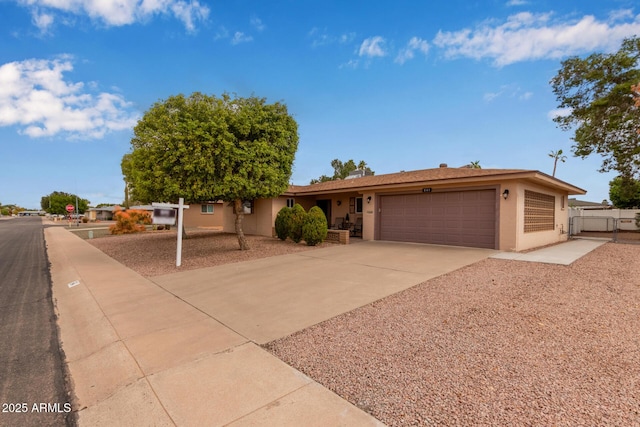 single story home with stucco siding, concrete driveway, and a garage