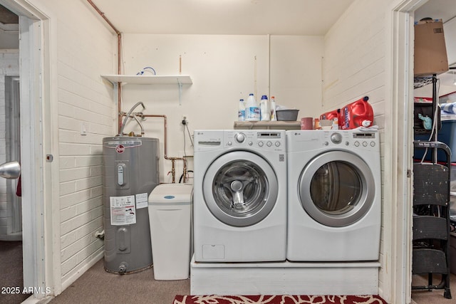 washroom featuring carpet flooring, electric water heater, laundry area, and washing machine and clothes dryer