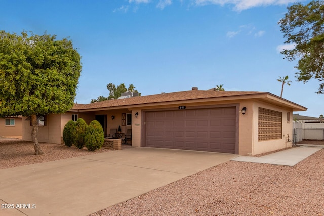 single story home with fence, stucco siding, a garage, driveway, and a gate