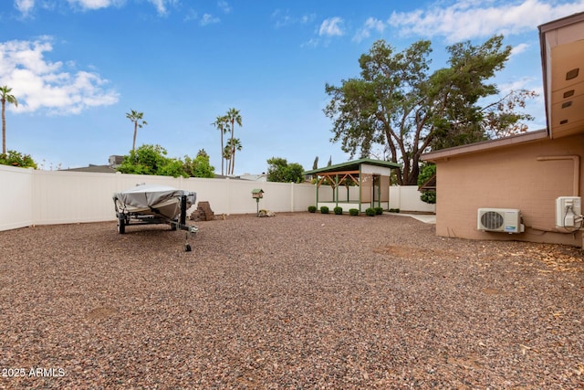 view of yard featuring a gazebo, a fenced backyard, and ac unit