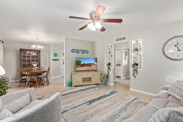 living area with visible vents, baseboards, light tile patterned flooring, and ceiling fan with notable chandelier