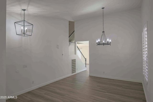 20722 N 38th St, Phoenix, AZ 85050 - unfurnished dining area featuring a chandelier, wood finished floors, stairway, and a high ceiling