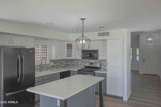 20722 N 38th St, Phoenix, AZ 85050 - kitchen featuring black appliances, tasteful backsplash, dark wood finished floors, pendant lighting, and a kitchen island