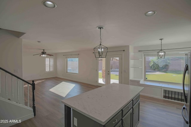 20722 N 38th St, Phoenix, AZ 85050 - kitchen featuring dark wood-style floors, hanging light fixtures, a kitchen island, a ceiling fan, and recessed lighting