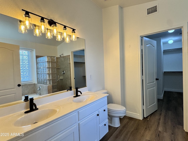 20722 N 38th St, Phoenix, AZ 85050 - full bathroom featuring a stall shower, wood finished floors, a walk in closet, double vanity, and a bath