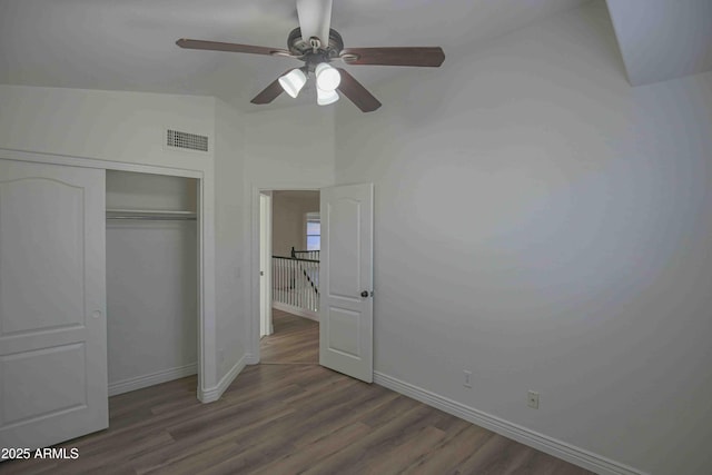 20722 N 38th St, Phoenix, AZ 85050 - unfurnished bedroom with wood finished floors, a closet, lofted ceiling, and ceiling fan