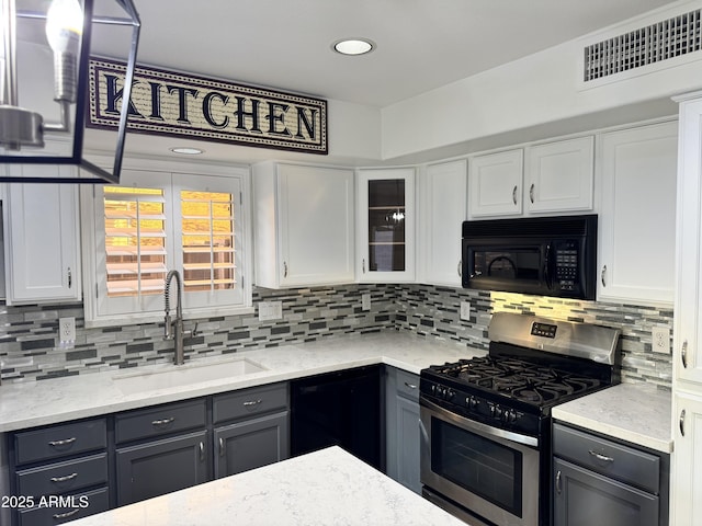 20722 N 38th St, Phoenix, AZ 85050 - kitchen with black appliances, decorative backsplash, and white cabinets