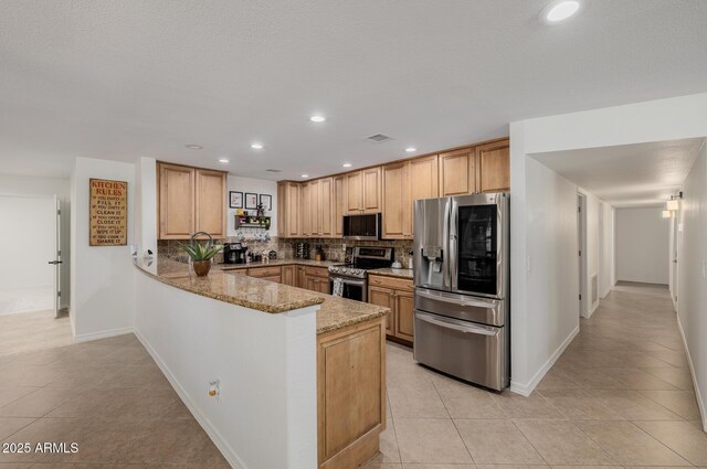 2350 E Melrose St, Gilbert, AZ 85297 - kitchen with stainless steel appliances, tasteful backsplash, a peninsula, light stone counters, and light tile patterned flooring