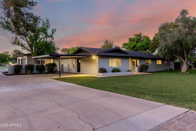 2350 E Melrose St, Gilbert, AZ 85297 - ranch-style home with concrete driveway, a front yard, an attached carport, and brick siding