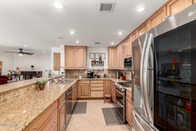 2350 E Melrose St, Gilbert, AZ 85297 - kitchen featuring appliances with stainless steel finishes, a sink, light stone countertops, backsplash, and recessed lighting