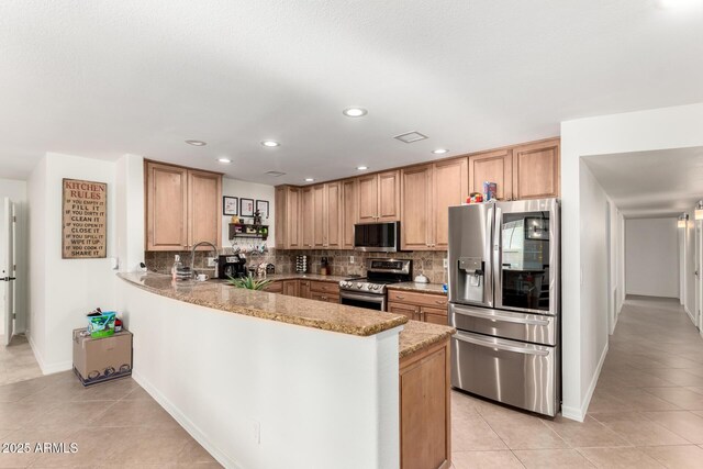 2350 E Melrose St, Gilbert, AZ 85297 - kitchen with appliances with stainless steel finishes, backsplash, light tile patterned flooring, a peninsula, and recessed lighting