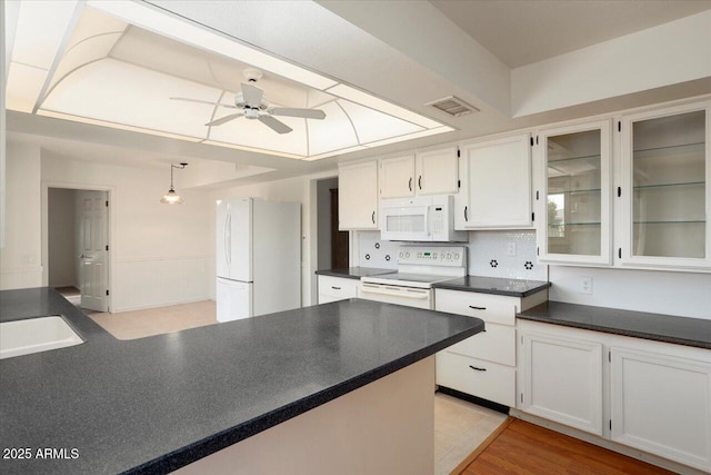 kitchen featuring decorative light fixtures, backsplash, white cabinets, ceiling fan, and white appliances