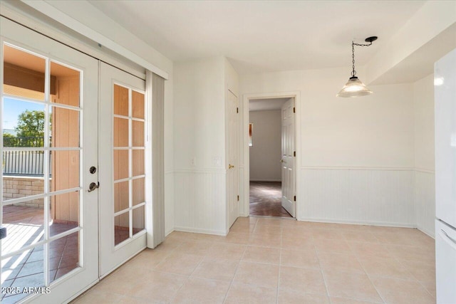 unfurnished room with french doors and light tile patterned floors