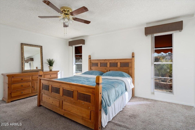 bedroom featuring a textured ceiling, ornamental molding, ceiling fan, and carpet